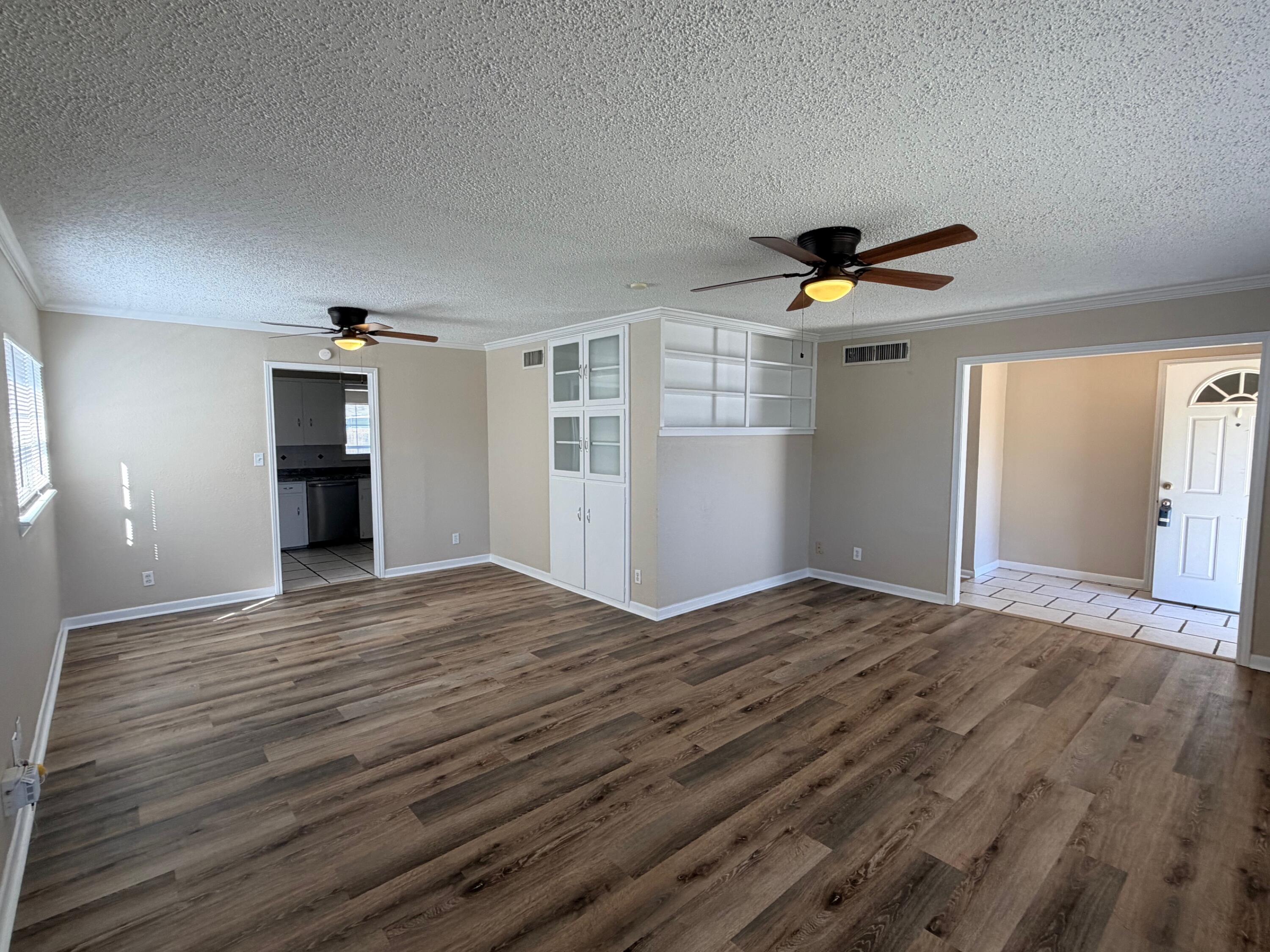 4310 42nd Street Lubbock, TX 79413 - Photo 3 of 25 a view of empty room with wooden floor and ceiling fan