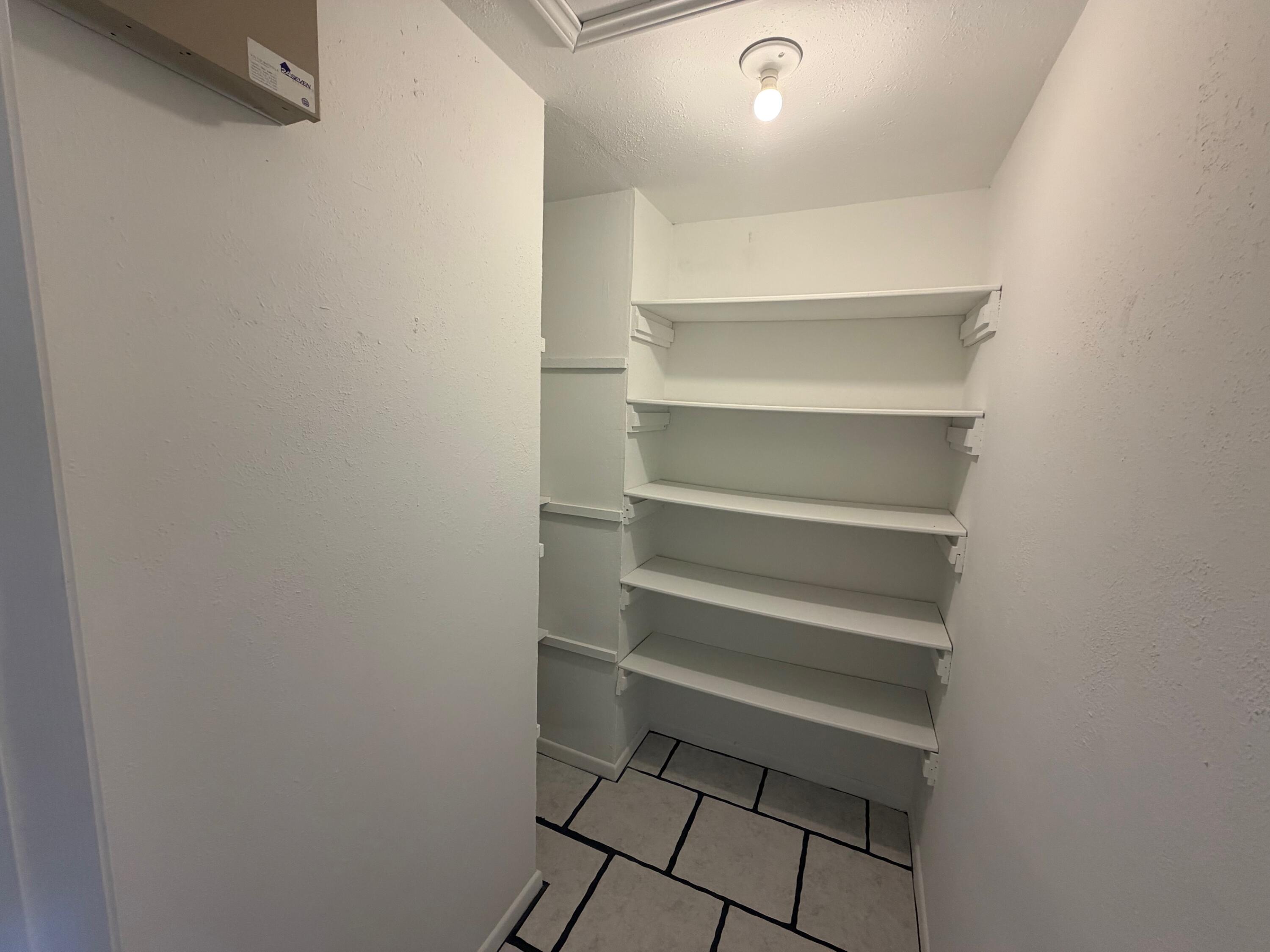 4310 42nd Street Lubbock, TX 79413 - Photo 5 of 25 a view of walk in closet with empty racks