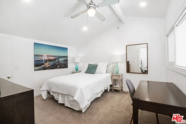 a bedroom with a bed and a table in it