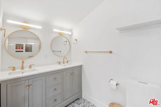 a bathroom with a double vanity sink and a mirror