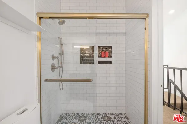 a bathroom with a shower and a sink
