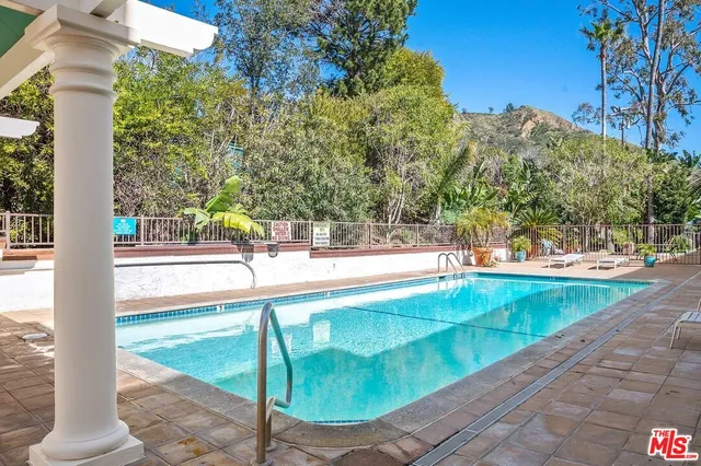 a view of a patio with a table and chairs