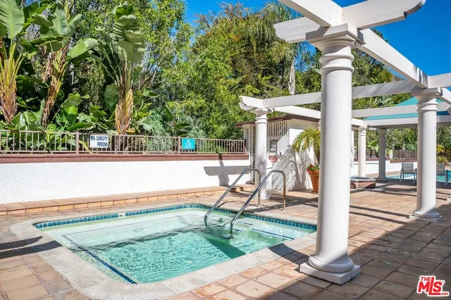 a living room with furniture a fireplace and a table