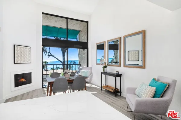 a living room with furniture and a floor to ceiling window