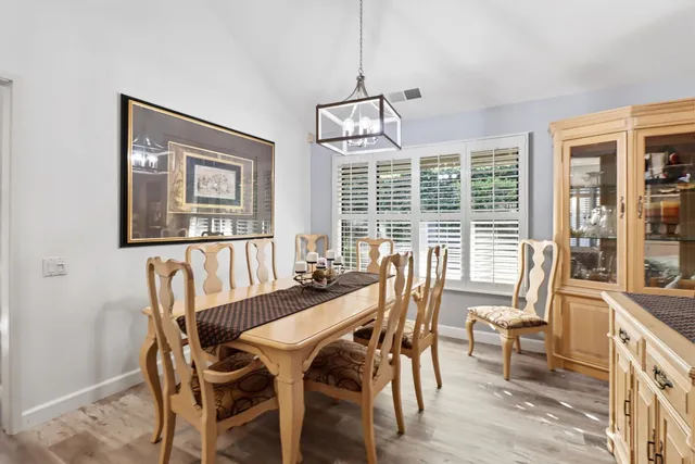 a view of a dining room with furniture large windows and wooden floor