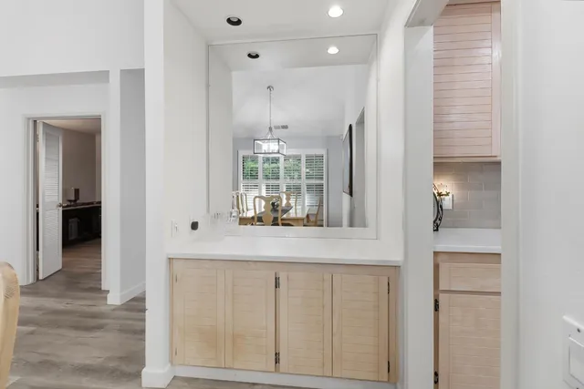 an entryway with wooden floor and cabinet