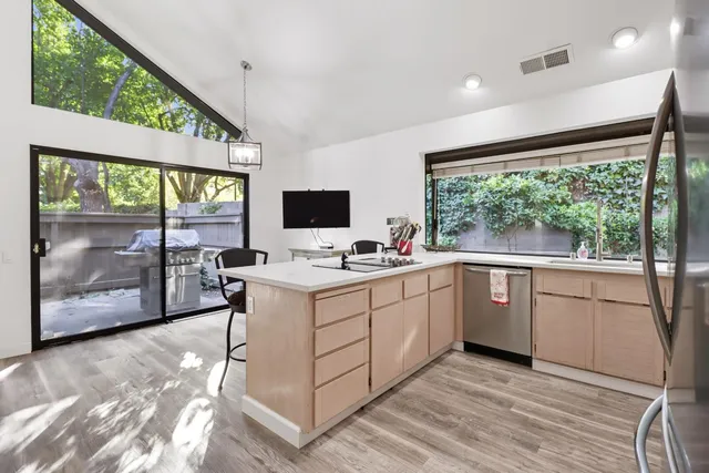 a kitchen with a sink window and cabinets