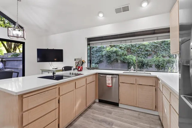 a kitchen with a sink and large mirror
