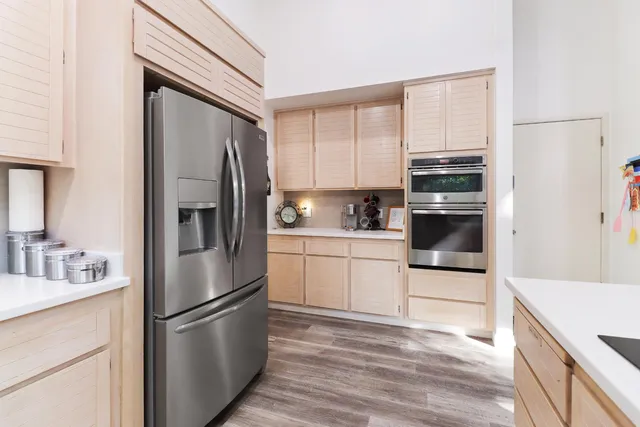 a kitchen with a refrigerator stove and sink
