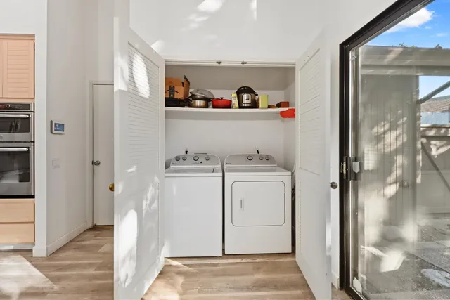 a view of a storage & utility room with closet dryer and washer