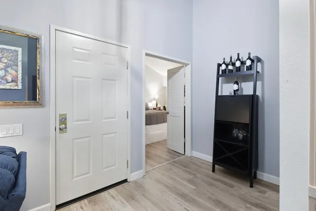 a view of a hallway with wooden floor and closet