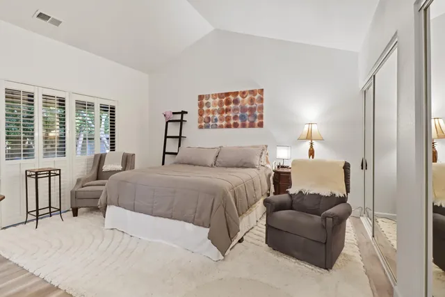 a bedroom with a bed and a large window