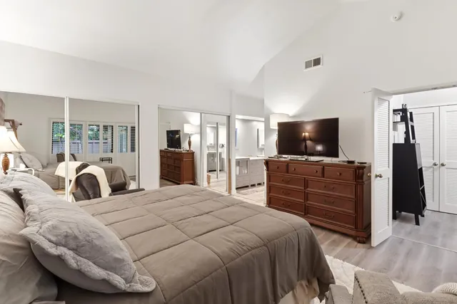 a bedroom with a bed and a flat screen tv