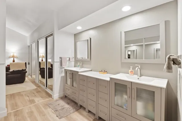 a spacious bathroom with a double vanity sink and a mirror