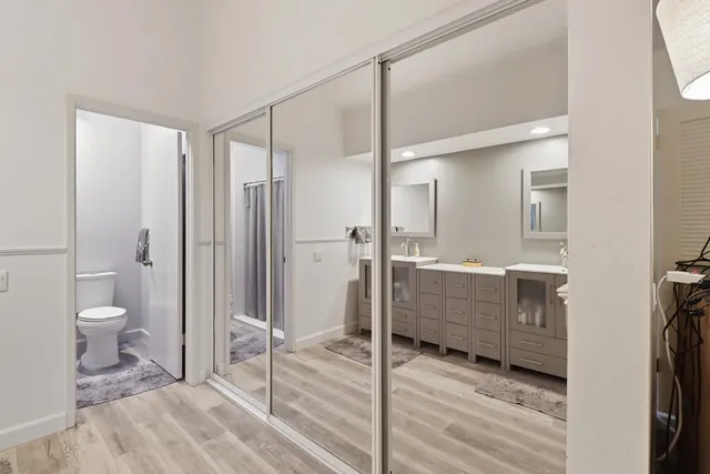 a bathroom with a toilet a sink and mirror