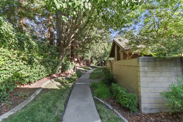 a view of a pathway of a house with a yard