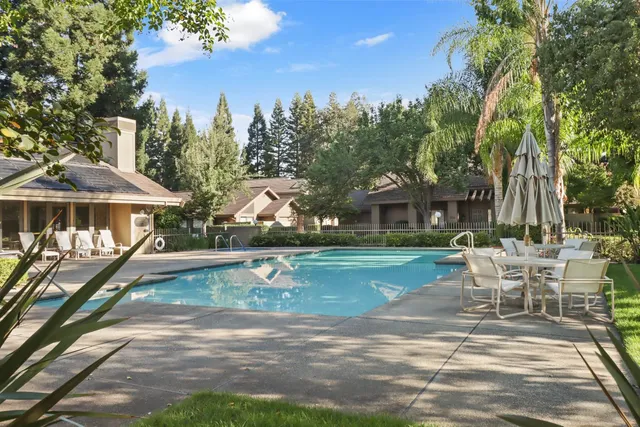 a view of a house with backyard porch and sitting area