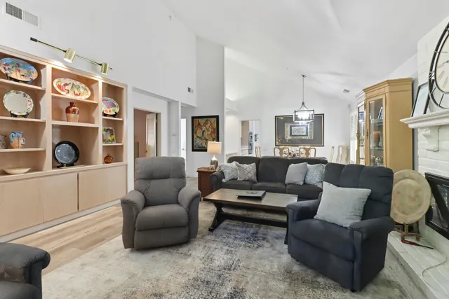 a living room with furniture cabinets and a window