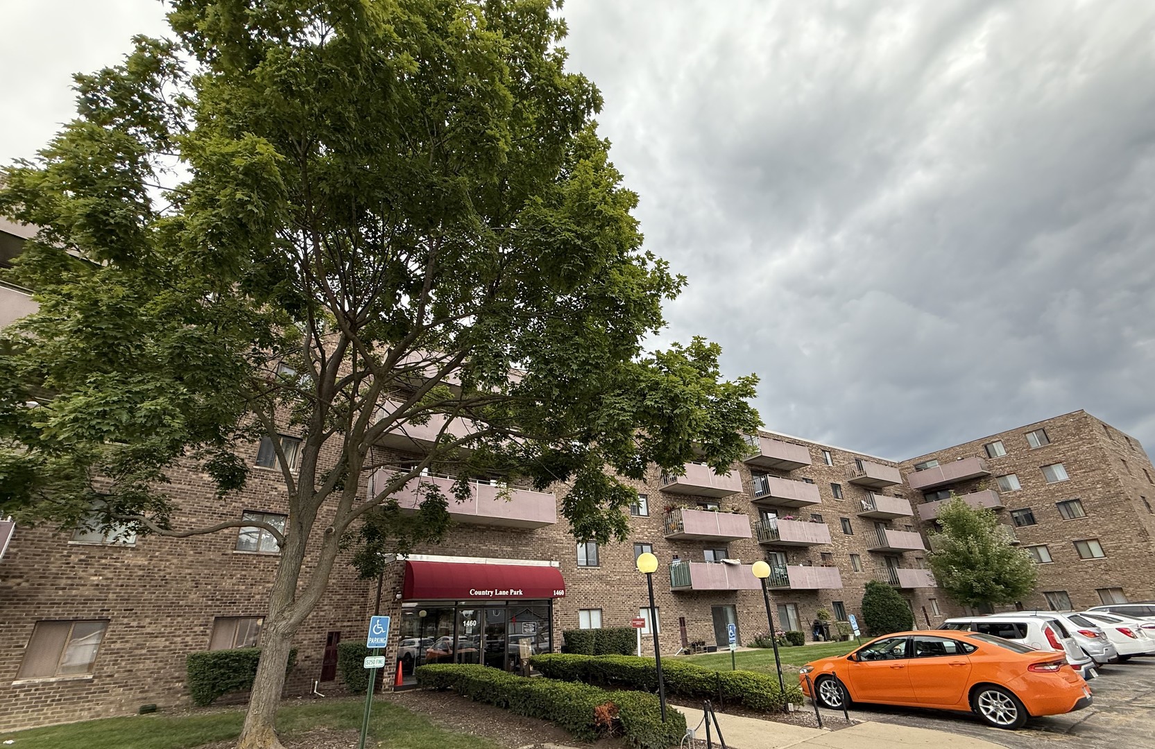 a front view of a building with trees