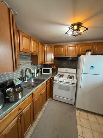 a kitchen with a stove a sink and a refrigerator