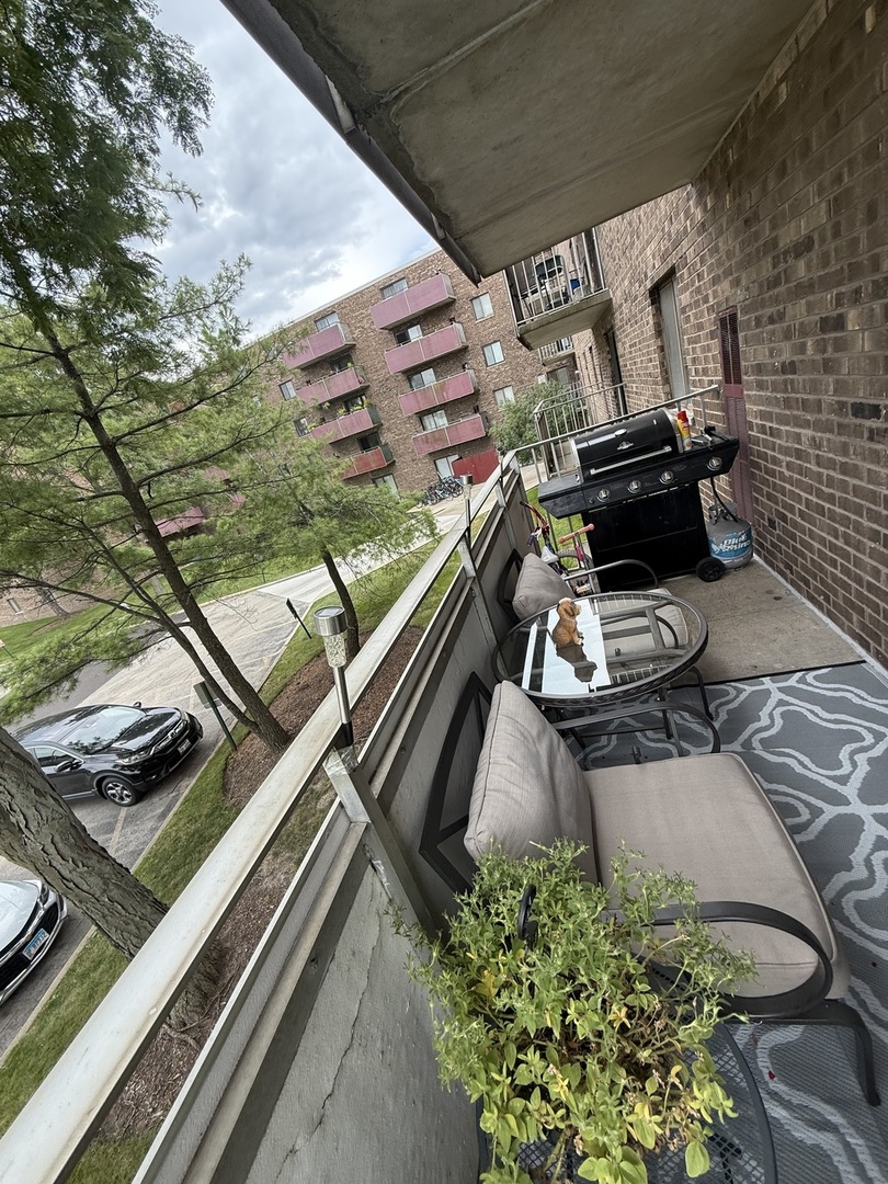 1460 Fairlane Drive, Unit 228 Schaumburg, IL 60193 - Photo 13 of 22 a view of a balcony with chairs and a stove