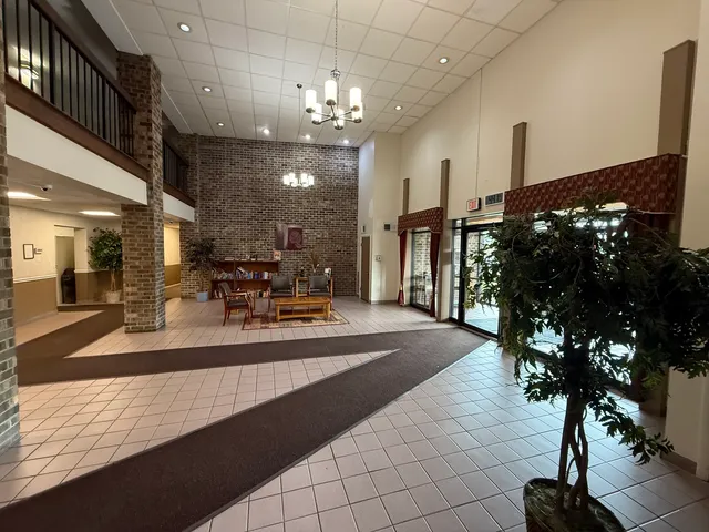 a view of a lobby with furniture and chandelier