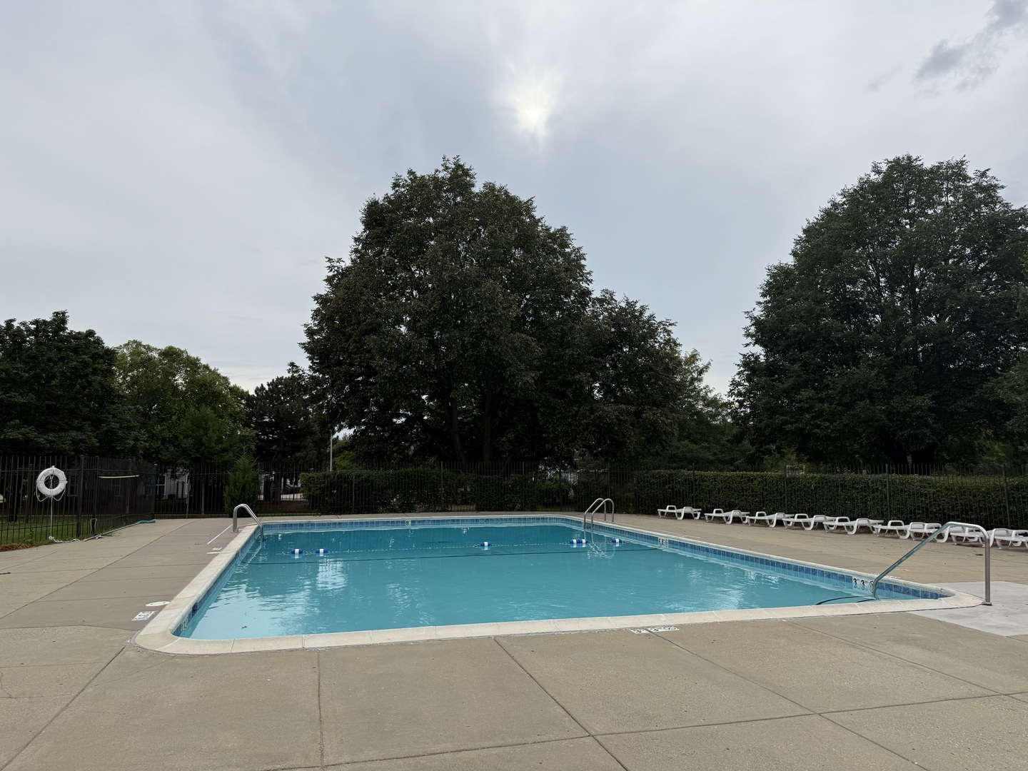 1460 Fairlane Drive, Unit 228 Schaumburg, IL 60193 - Photo 22 of 22 a view of a swimming pool with a yard and large trees