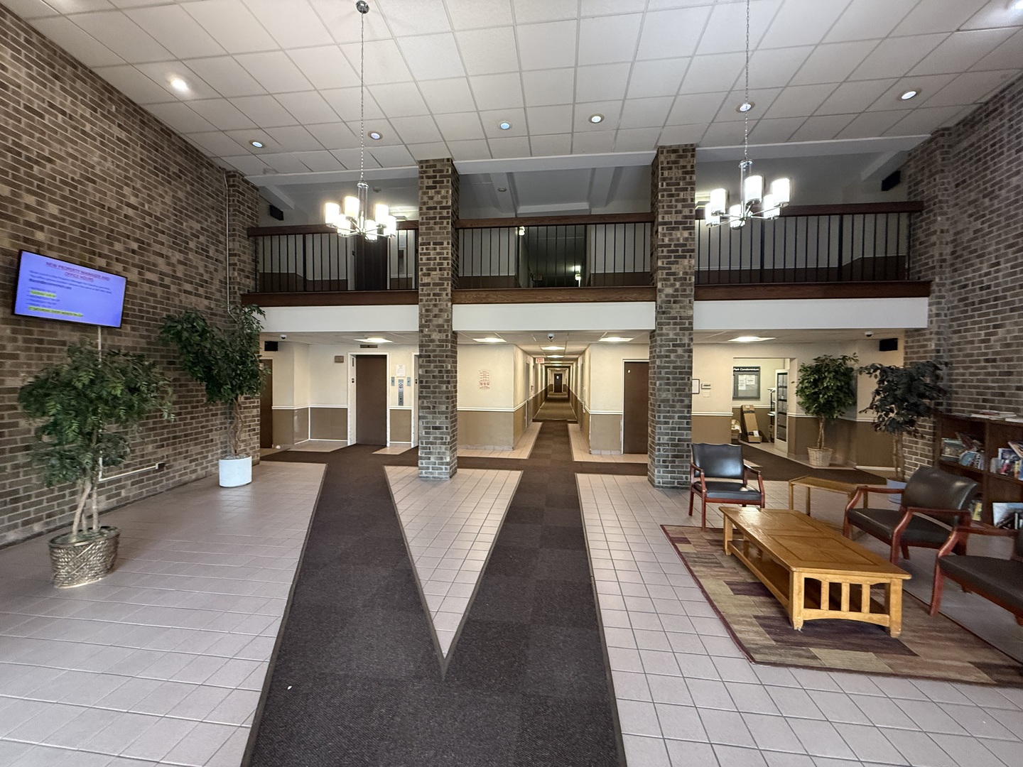 1460 Fairlane Drive, Unit 228 Schaumburg, IL 60193 - Photo 3 of 22 a living room with fireplace furniture and a flat screen tv