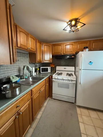 a kitchen with a stove cabinets and a sink