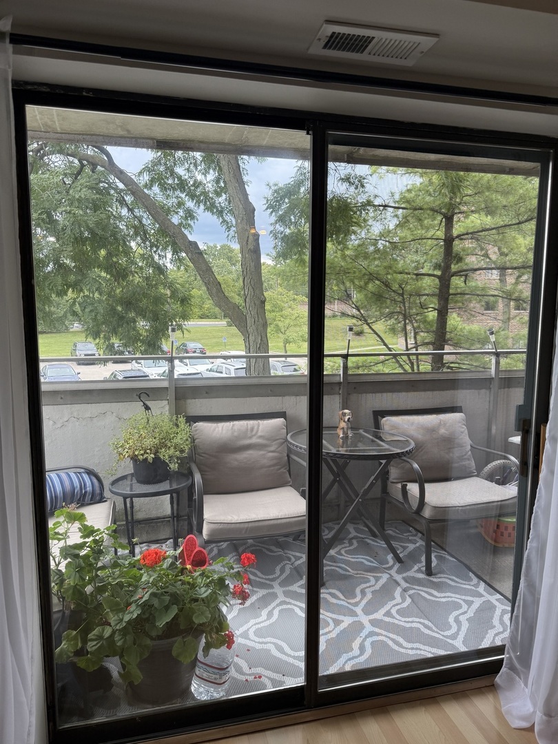 1460 Fairlane Drive, Unit 228 Schaumburg, IL 60193 - Photo 8 of 22 a view of a living room with furniture and a floor to ceiling window