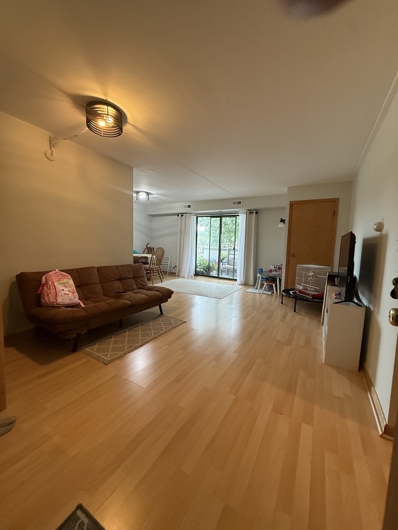 1460 Fairlane Drive, Unit 228 Schaumburg, IL 60193 - Photo 9 of 22 a living room with furniture and a wooden floor