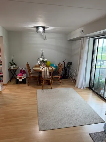 a living room with furniture and a floor to ceiling window