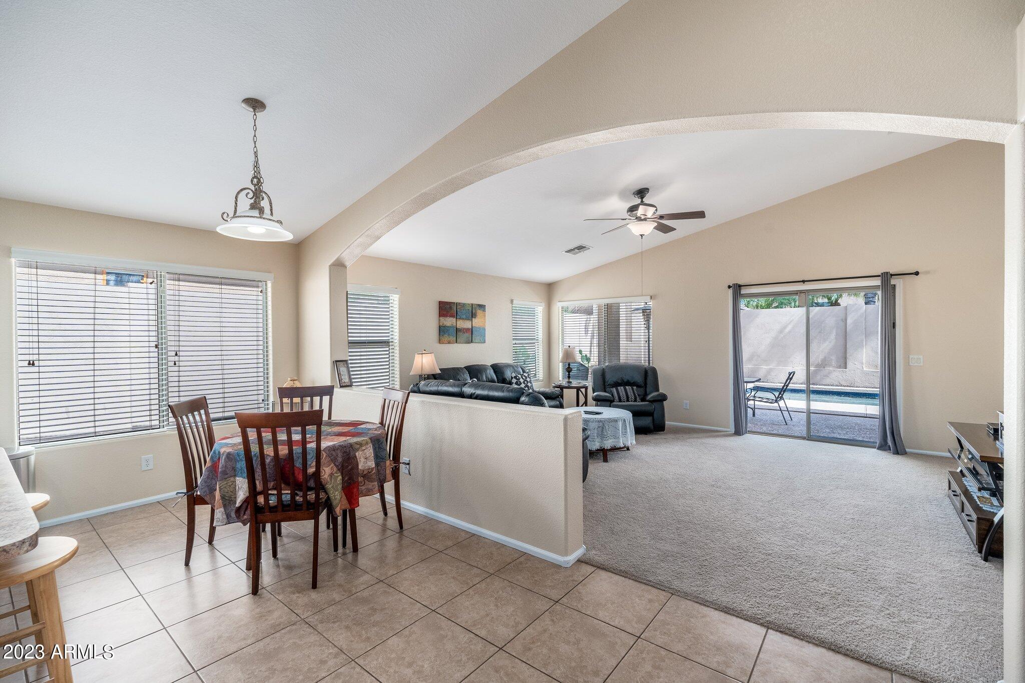 2215 West Peak View Road Phoenix, AZ 85085 - Photo 14 of 49 a view of a dining room with furniture and chandelier