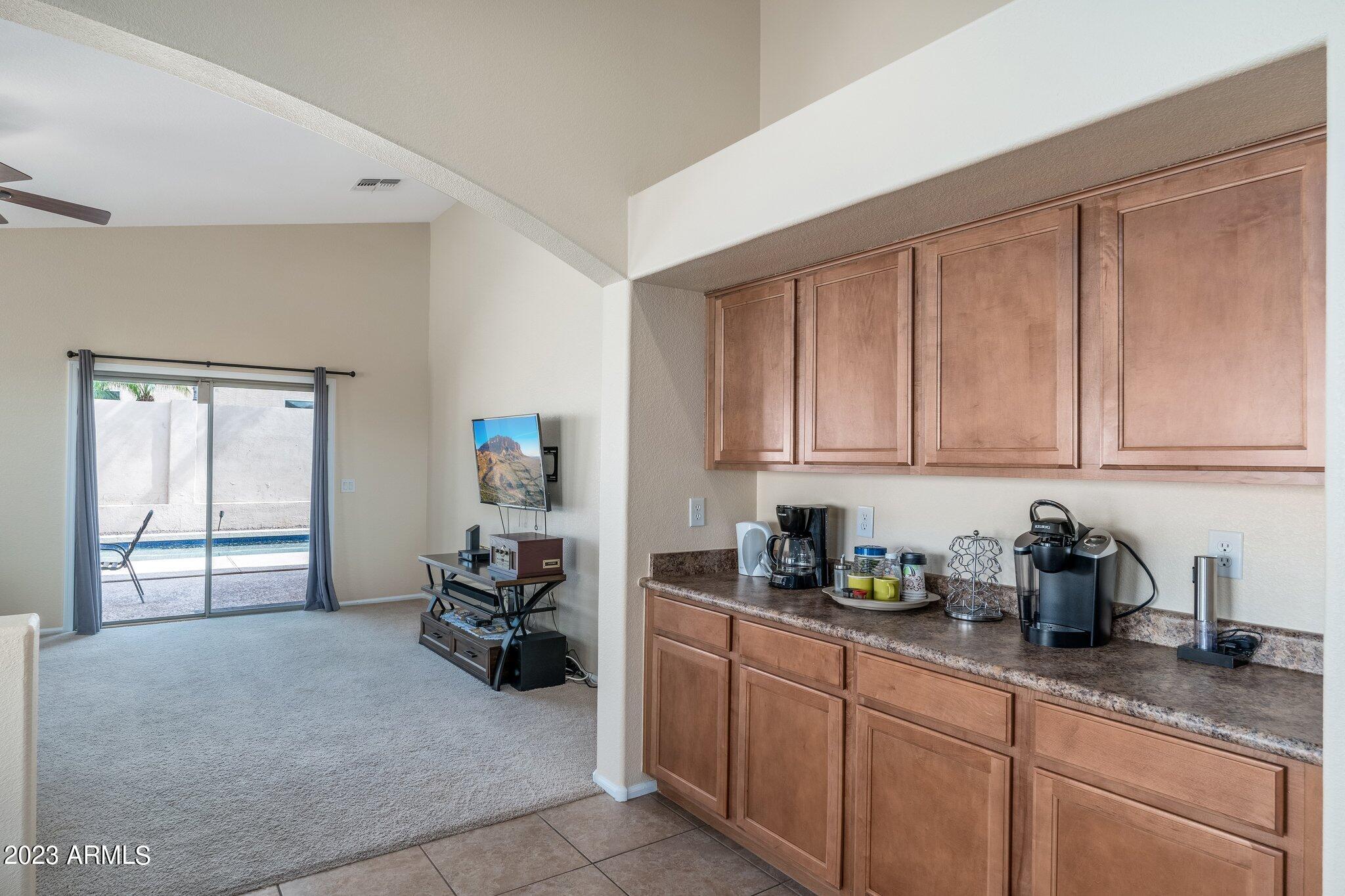 2215 West Peak View Road Phoenix, AZ 85085 - Photo 15 of 49 a kitchen with a cabinets and window