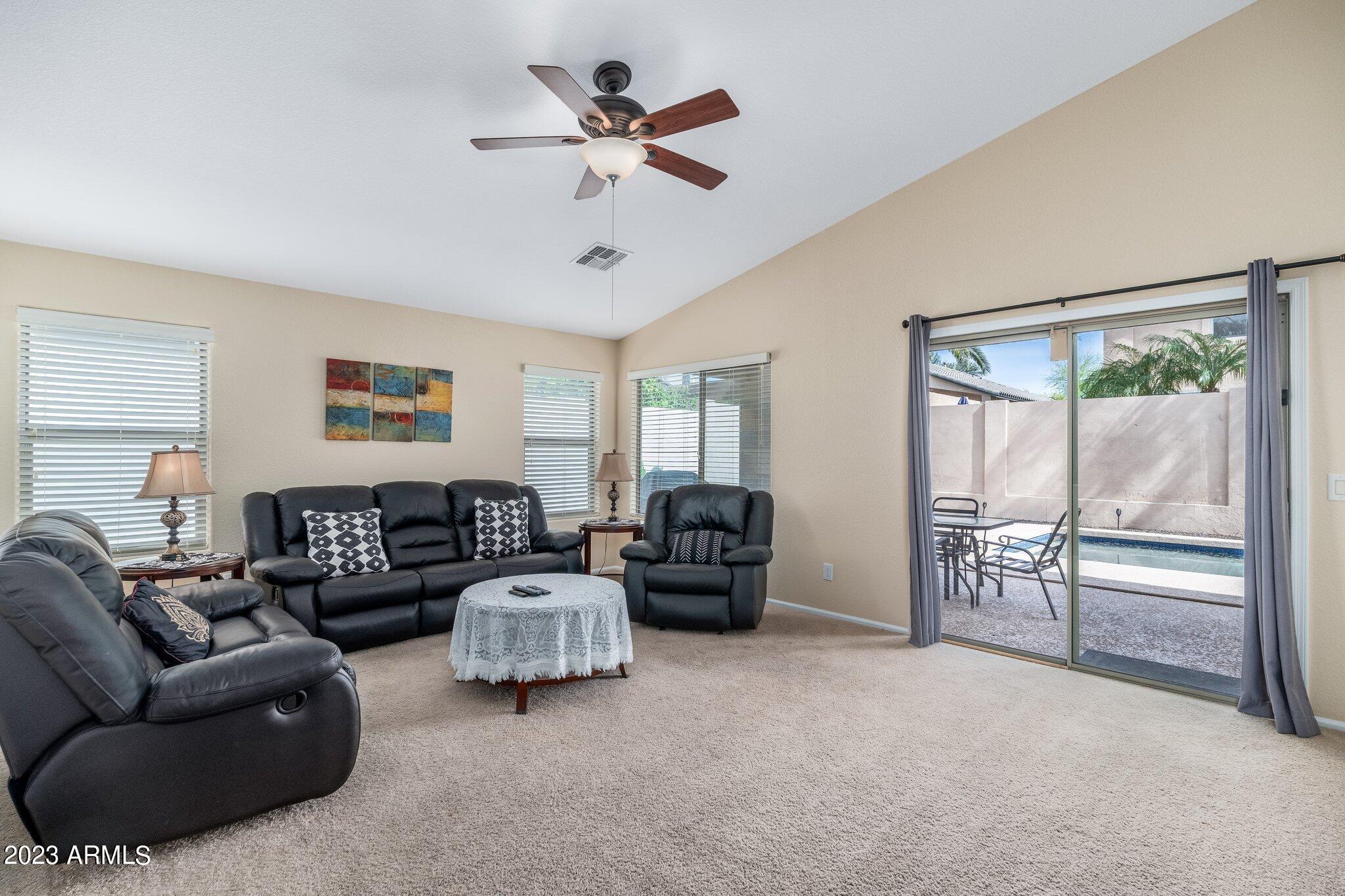 2215 West Peak View Road Phoenix, AZ 85085 - Photo 19 of 49 a living room with furniture and a large window
