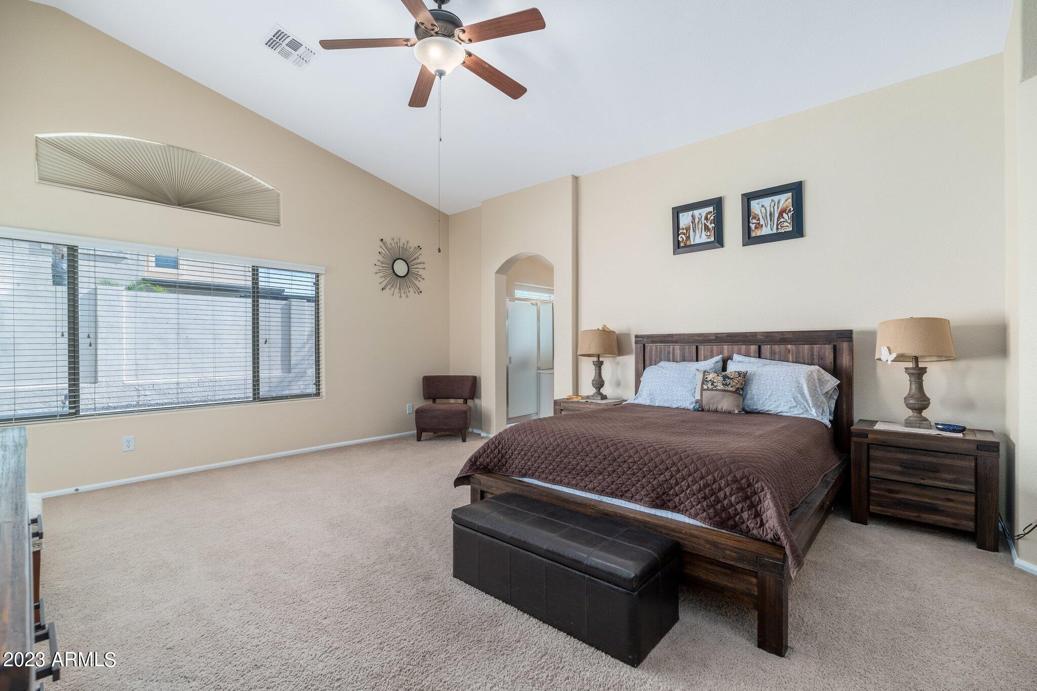2215 West Peak View Road Phoenix, AZ 85085 - Photo 22 of 49 a bedroom with a bed lamp and closet