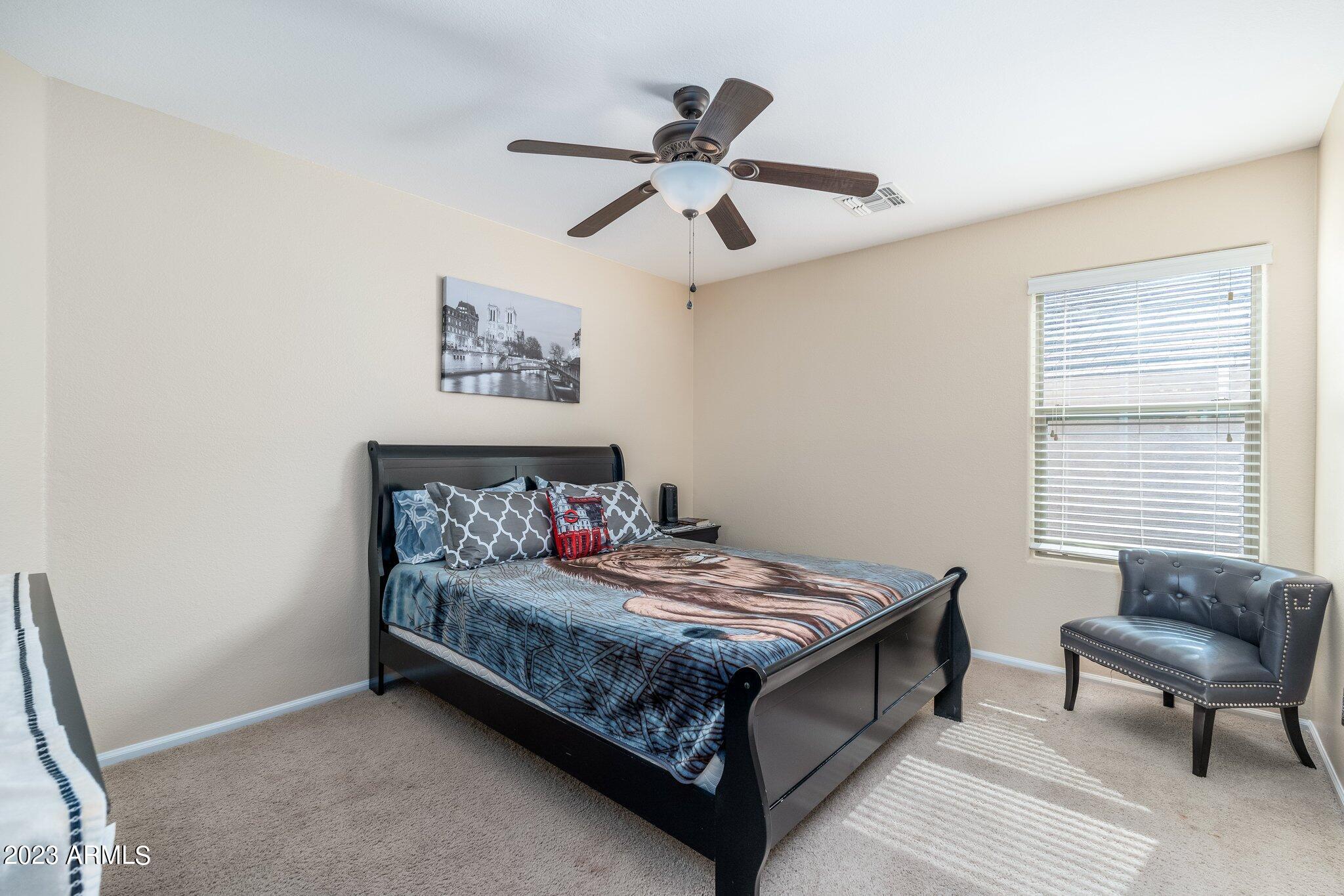 2215 West Peak View Road Phoenix, AZ 85085 - Photo 27 of 49 a bedroom with a bed and a window