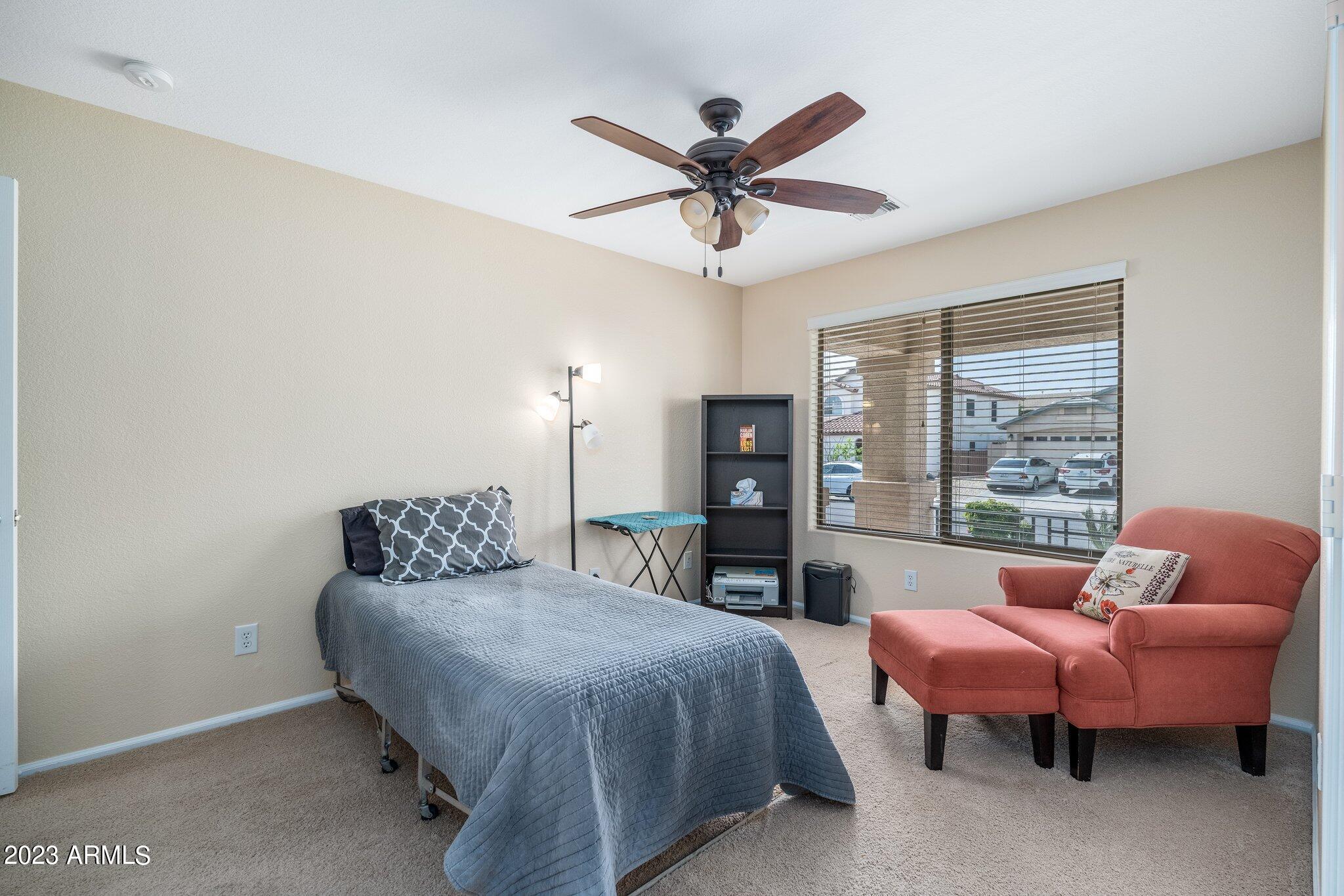 2215 West Peak View Road Phoenix, AZ 85085 - Photo 29 of 49 a spacious bedroom with a bed and a window