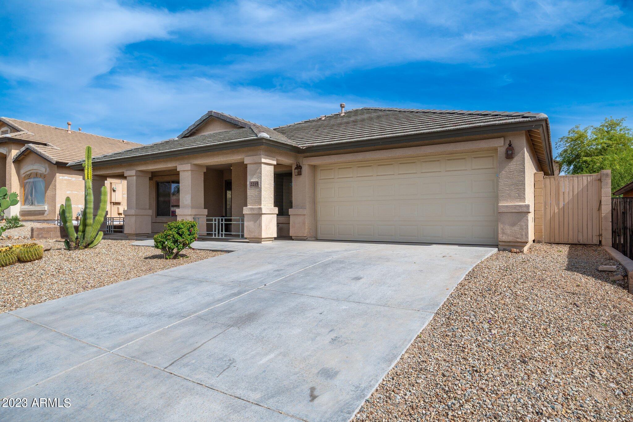2215 West Peak View Road Phoenix, AZ 85085 - Photo 3 of 49 a view of a house with a yard and potted plants