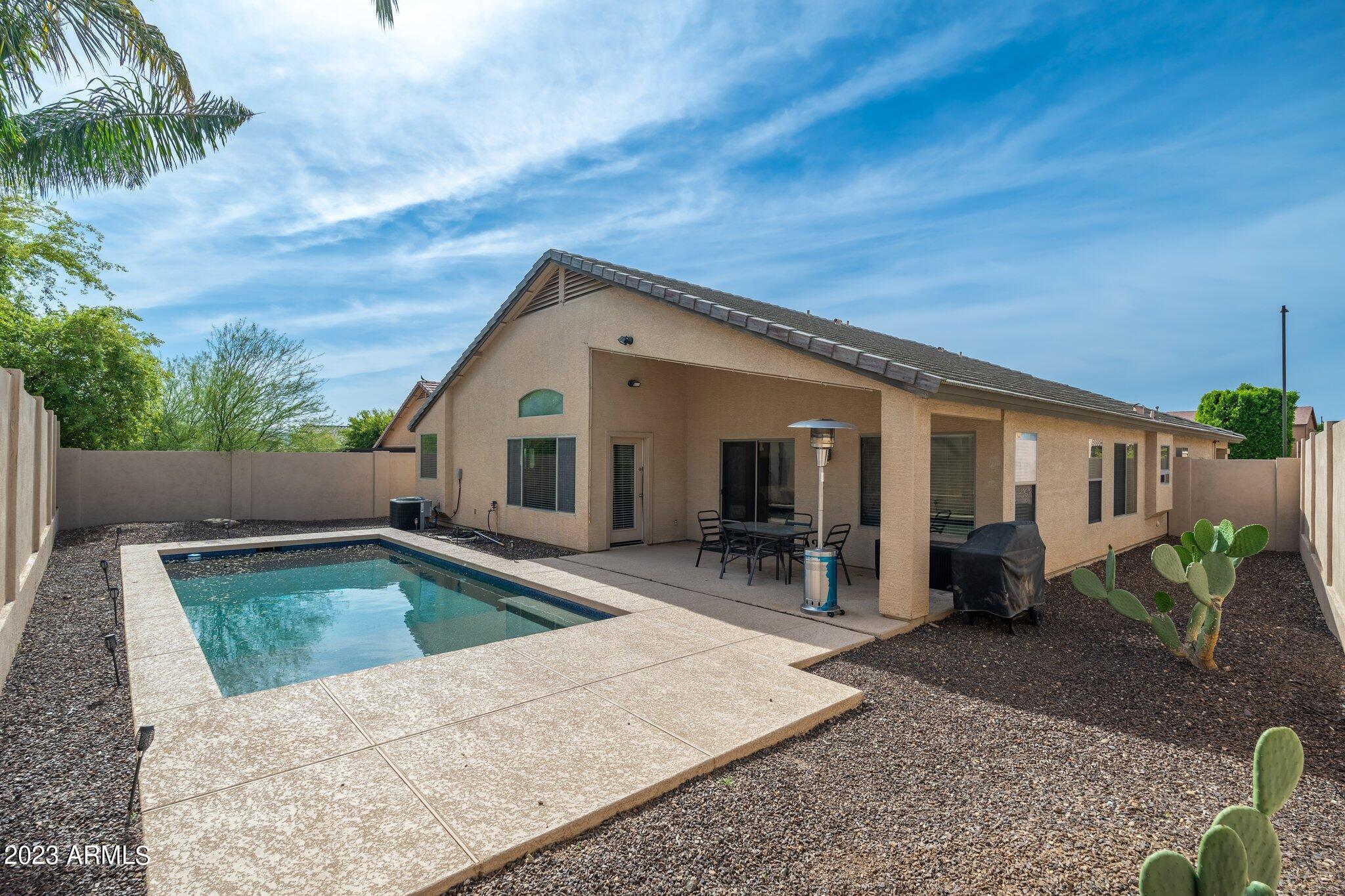 2215 West Peak View Road Phoenix, AZ 85085 - Photo 35 of 49 a view of a house with backyard and sitting area