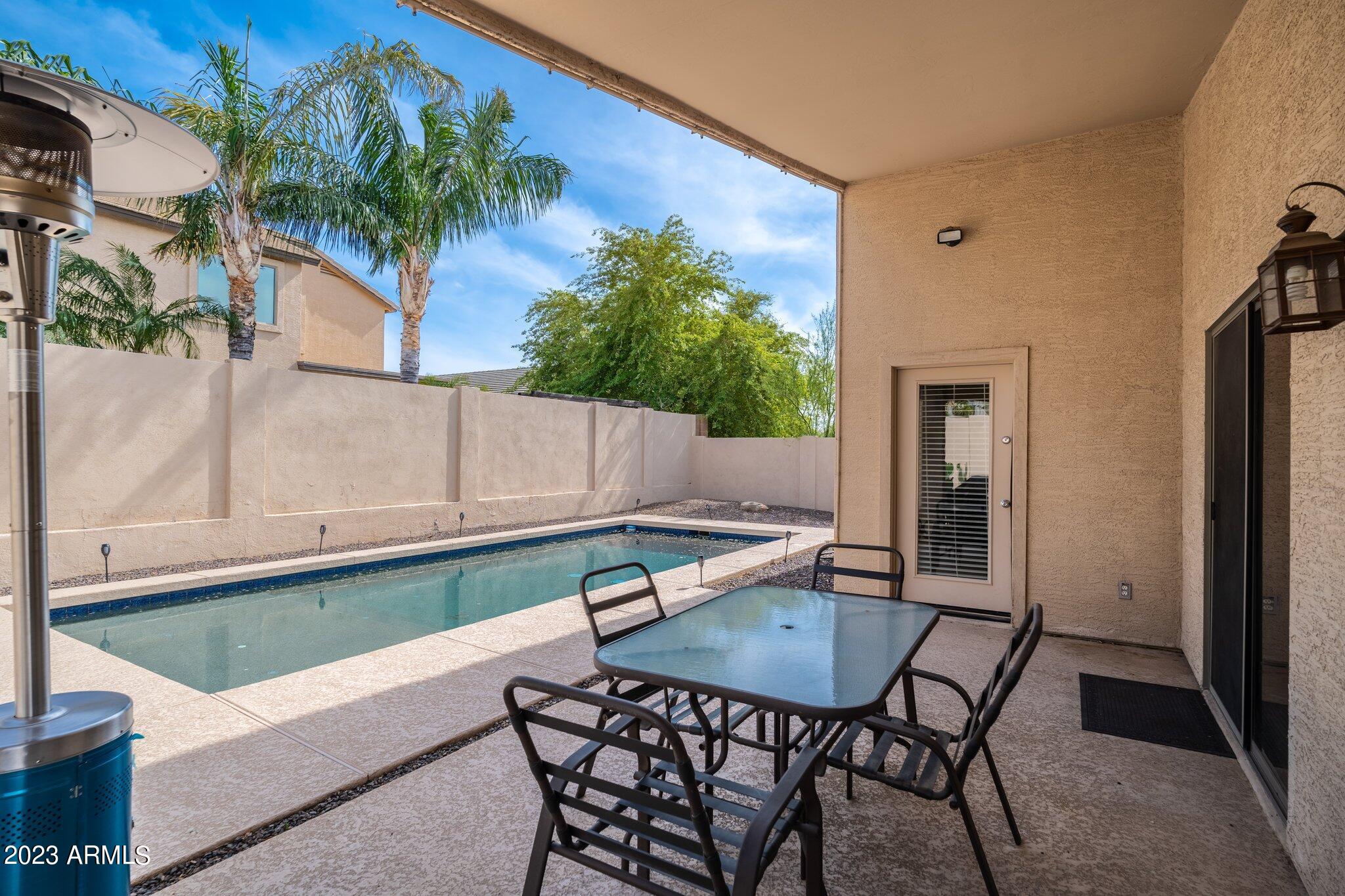 2215 West Peak View Road Phoenix, AZ 85085 - Photo 37 of 49 a backyard of a house with table and chairs