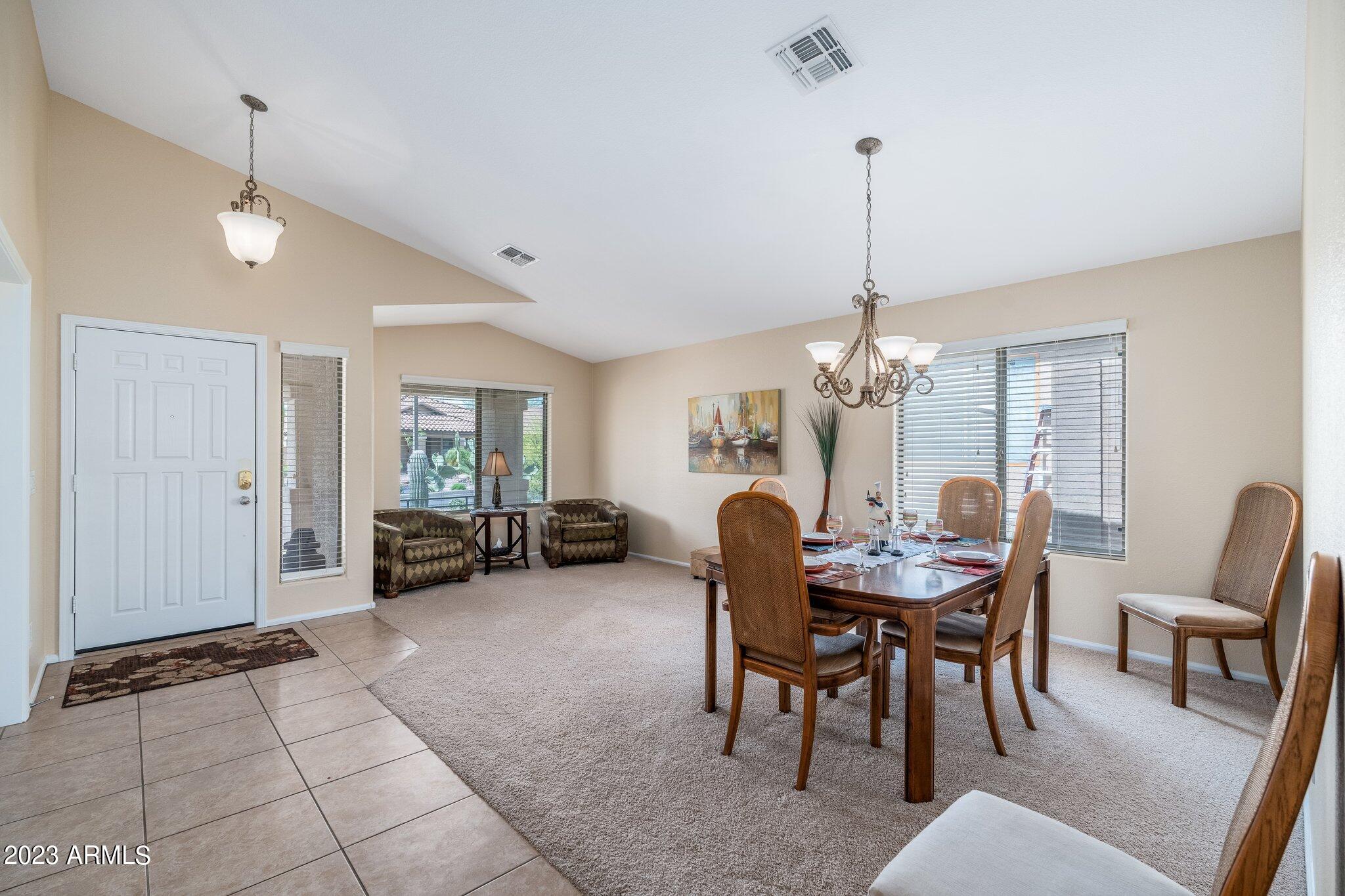 2215 West Peak View Road Phoenix, AZ 85085 - Photo 5 of 49 a view of a dining room with furniture and chandelier
