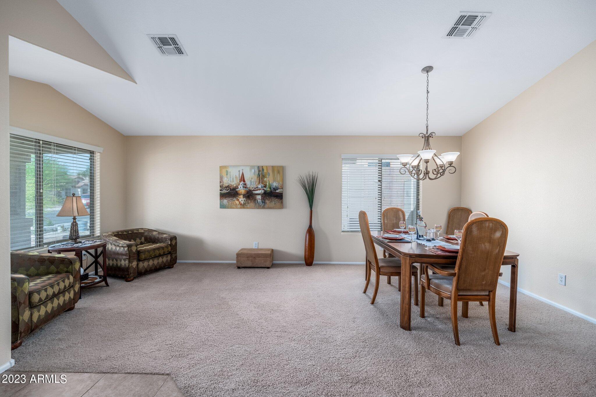 2215 West Peak View Road Phoenix, AZ 85085 - Photo 7 of 49 a view of a livingroom with furniture and chandelier