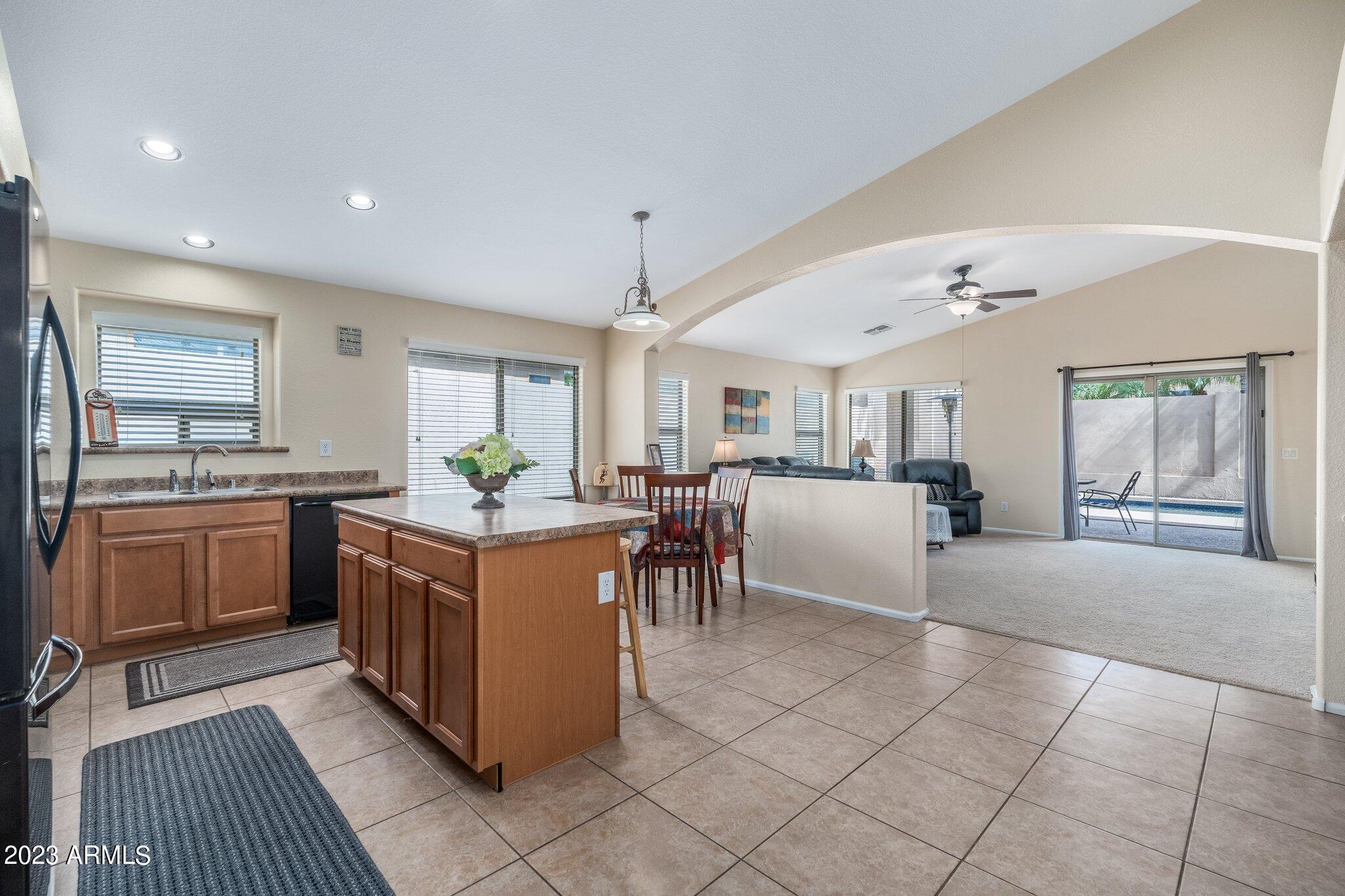 2215 West Peak View Road Phoenix, AZ 85085 - Photo 8 of 49 a open kitchen with stainless steel appliances granite countertop a stove and a sink