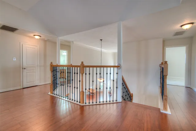 a view of a hallway with wooden floor
