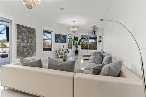 a living room with lots of furniture wooden floor and a table