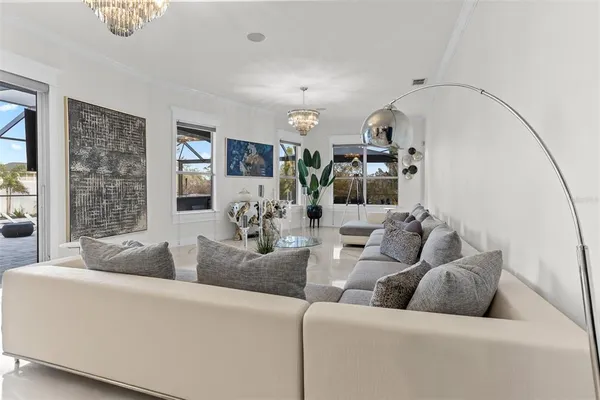 a living room with lots of furniture wooden floor and a table