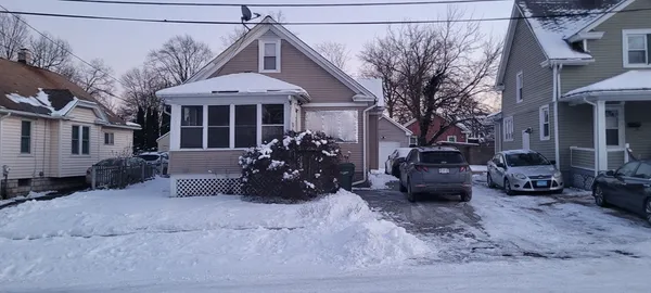 a view of a house with a yard and sitting area