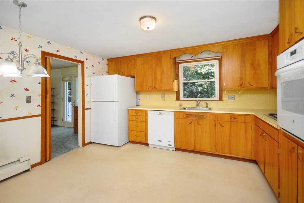 13 Beverly Road Acton, MA 01720 - Photo 11 of 23 a kitchen with a refrigerator and a sink