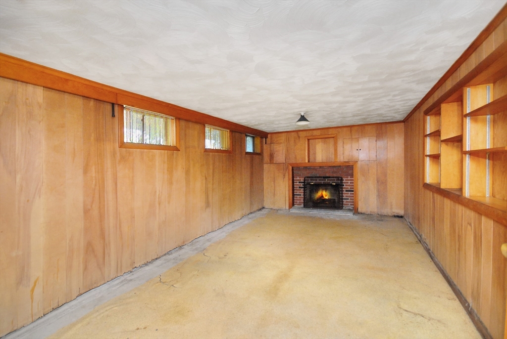 13 Beverly Road Acton, MA 01720 - Photo 18 of 23 a view of an empty room with a fireplace and a window